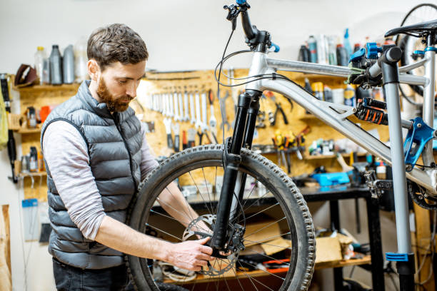 istock Man repairing a bicycle in the workshop 1139951149