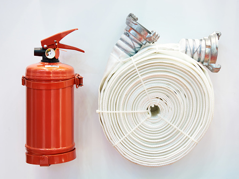 Powder fire extinguisher and fire hose on stand