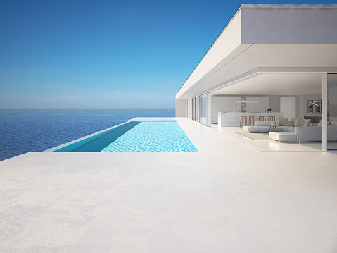3D render of a single-storey, luxury villa in modern and minimalist architecture.\nThe villa's floor-to-ceiling windows provide an uninterrupted view of the stunning tropical ocean backdrop.\nThe villa's private backyard features a swimming pool set within a wooden deck, complete with two loungers for relaxation.