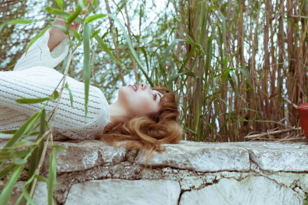 Teenage Girls Lying Down Rock