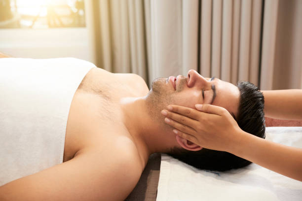 istock Man receiving face massage at spa 1139953001