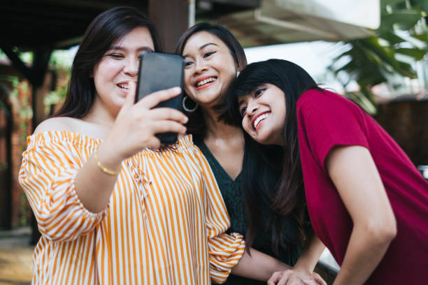 istock Three Young Beautiful Women Taking Photo Together 1139957377