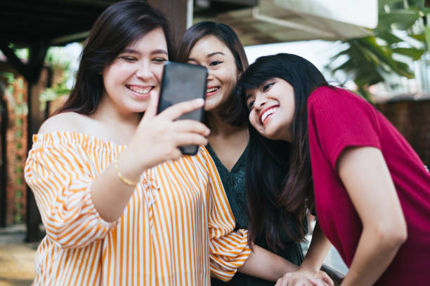 istock Three Young Beautiful Women Taking Photo Together 1139957382