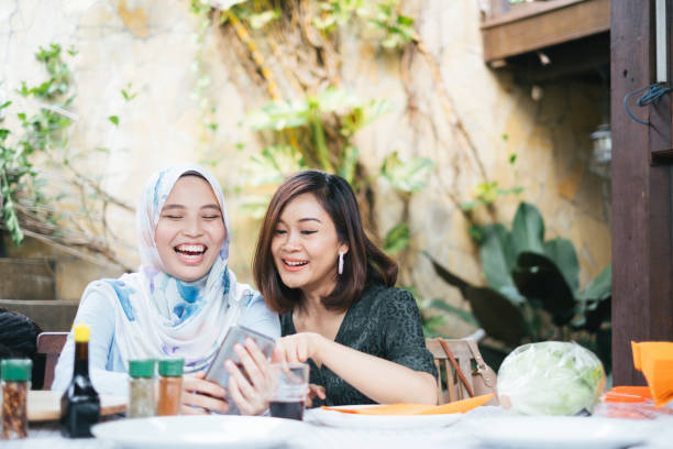 istock Two Young Cheerful Women Looking at Mobile Phone 1139957391