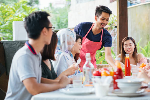 istock Group of Friends Having Meal Together 1139959636