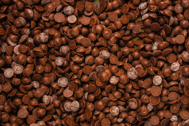 istock chocolate drops (sweets). food background. copy space. top 1139959740