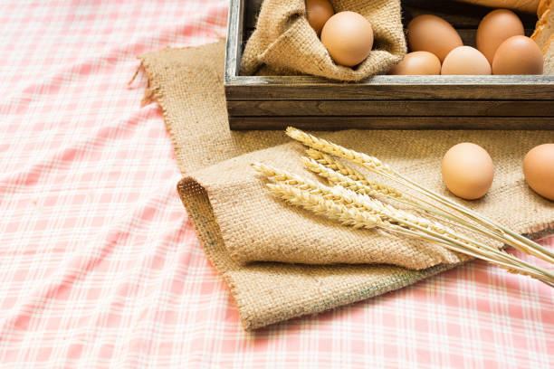 istock Breakfast and baked bread concept. Fresh fragrant bread and egg on the fabric sack. On wooden table. morning breakfast. 1139960314