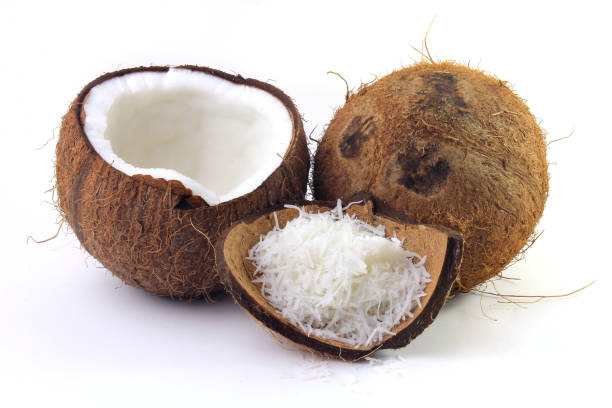 istock fresh coconut flakes placed in bark and shell isolated on white background. Front view 1139963020