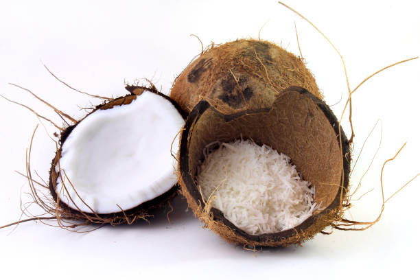 istock fresh coconut flakes placed in bark and shell isolated on white background. Front view 1139963023