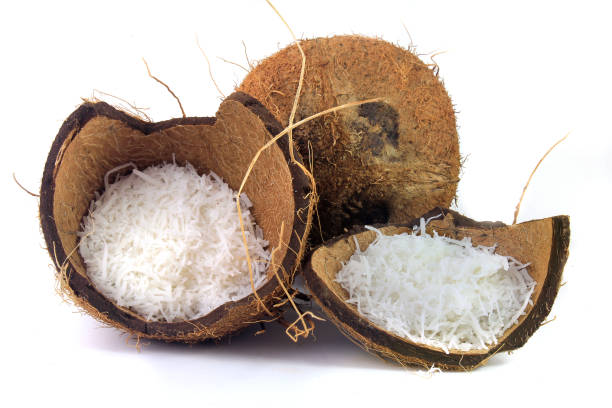 istock fresh coconut flakes placed in bark and shell isolated on white background. Front view 1139963116