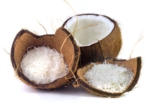 istock fresh coconut flakes placed in bark and shell isolated on white background. Front view 1139963130