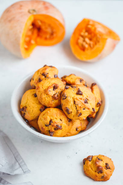 istock Pumpkin cookies with chocolate chips made from cake mix in a white ceramic bowl. 1139963198