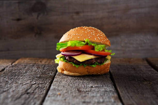 istock Close Up of Burger on Rustic Wooden Surface 1139964240
