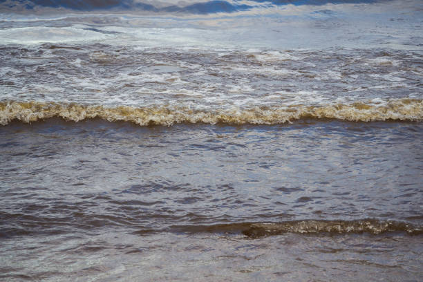 istock Stormy sea wave at sunset. 1139966817