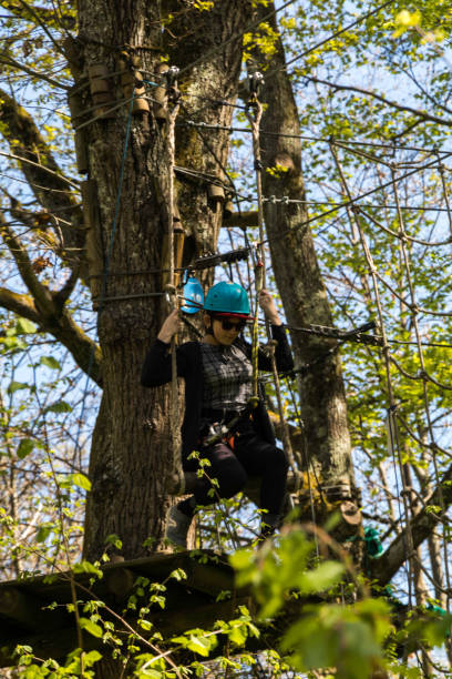 istock Climbing course in the forest with person in action 1139969116