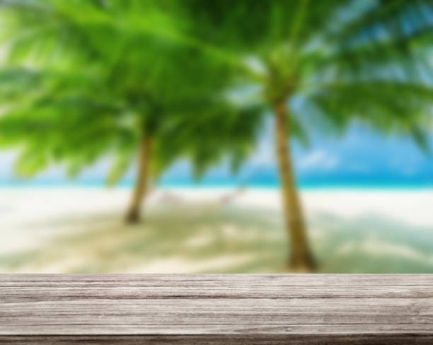 istock wooden table top with blur ocean background summer concept - Image 1139972206