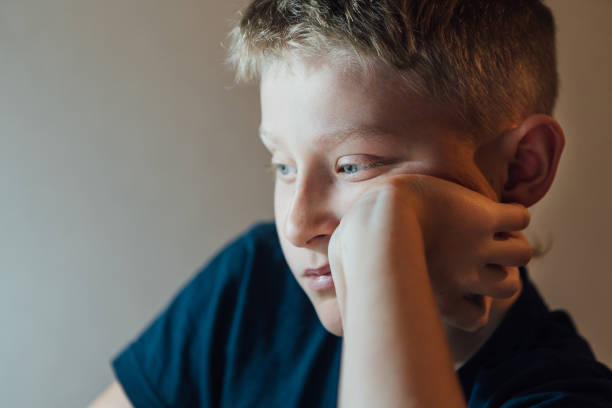 istock Lonely Sad boy thinking about something boy portrait. 1139972313