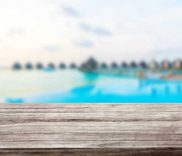 istock wooden table top with blur ocean background summer concept - Image 1139972808