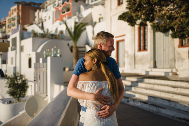 young couple honeymoon on the most romantic island Santorini, Greece, view of Santorini stock photo