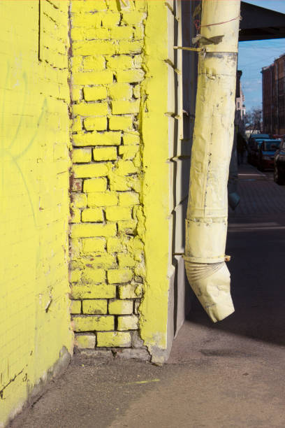istock Yellow brick house corner and drainpipe on a sunny day 1139974941