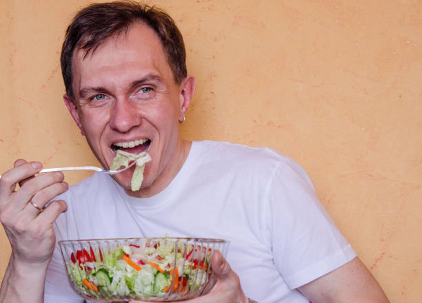 istock young man takes ready vegan salad 1139976462