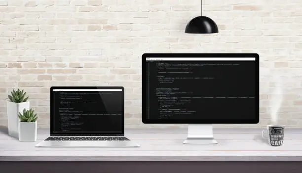 Web development on computer and laptop with concept of code editor on display.