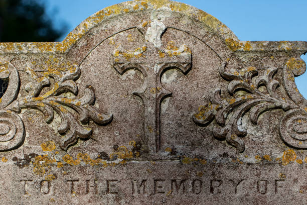 istock Genealogy and ancestry. Old graveyard headstone 'to the memory of'. 1139982704
