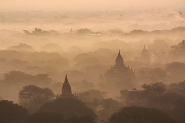 Bagan Temples at Sunrise An aerial view of some of the many temples in Bagan, Myanmar, through the early morning mist. bagan archaeological zone stock pictures, royalty-free photos & images