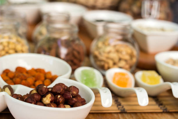 Various piles of mixed gummy candy and nuts. Healthy collection of nuts and seeds