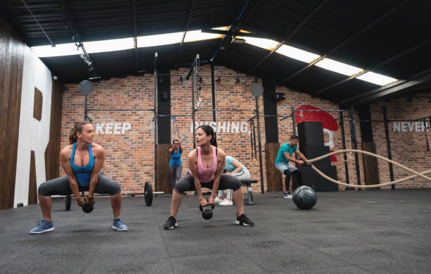 istock Female coach and customer working out together with a dumbbell 1139987605