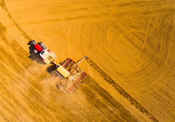 istock Aerial view to a Tractor with sowing machine working on a  field. Agriculture from above. 1139993113
