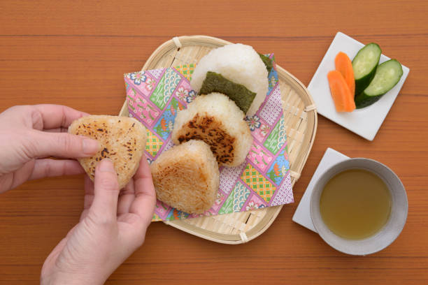 istock Japanese rice ball and female hand 1139993194