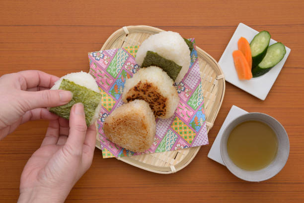 istock Japanese rice ball and female hand 1139993210
