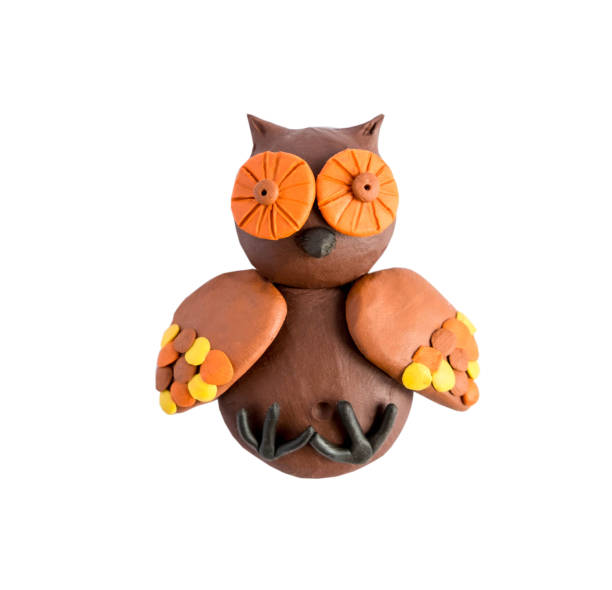istock Owl fashioned from plasticine by a child isolated on a white background. Plasticine owl 1139994452