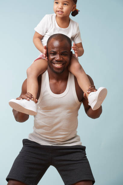 istock Father is doing squats, using his little daughter as additional weight 1139995166