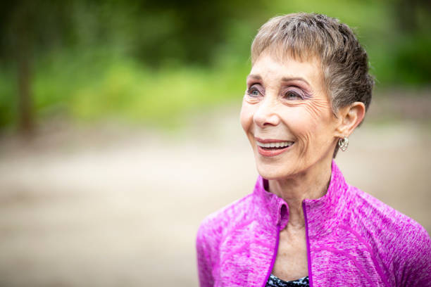 istock Senior Woman Standing in Forest 1139999394