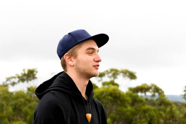 istock Portrait of young man with cap, side view, white backgroun with copy space 1139999431