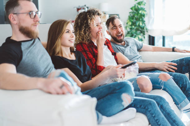 istock Four friends watching tv 1140000615