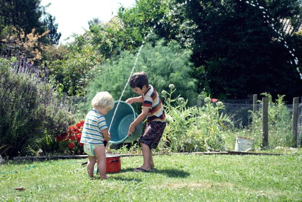 istock Children Playing with Water in Garden 1140001449
