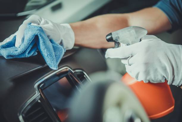Worker Cleaning Car Dashboard Worker Cleaning Car Dashboard. Taking Care of Vehicle Interior. Automotive Services. car interior stock pictures, royalty-free photos & images