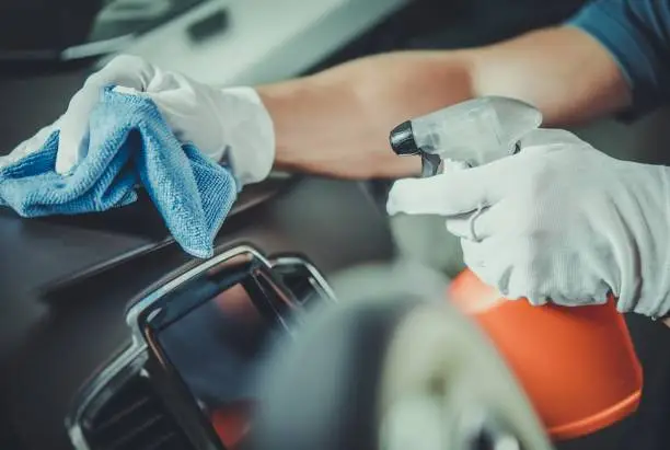 Worker Cleaning Car Dashboard. Taking Care of Vehicle Interior. Automotive Services.