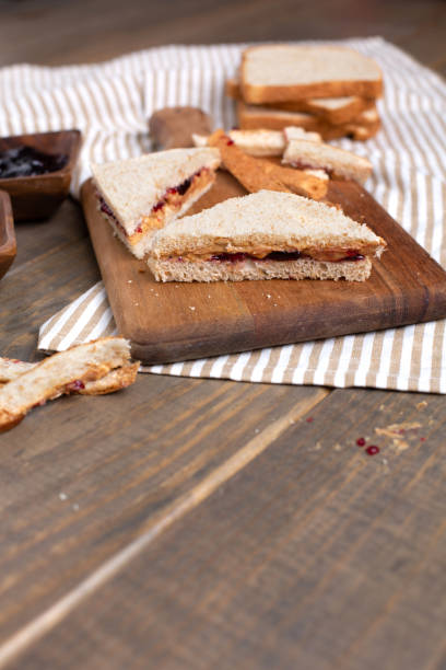 istock Making a Peanut Butter and Jelly Sandwich on a Wooden Table 1140002373
