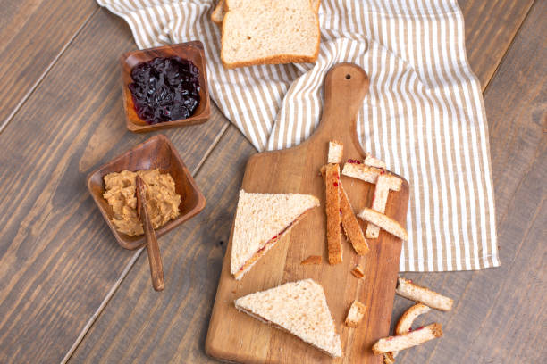 istock Making a Peanut Butter and Jelly Sandwich on a Wooden Table 1140002383