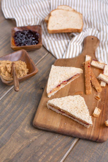 istock Making a Peanut Butter and Jelly Sandwich on a Wooden Table 1140002393