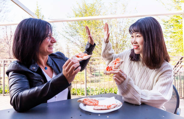 istock young multi-ethnic female friends high five 1140008152