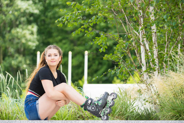 istock Young woman riding roller skates 1140011359