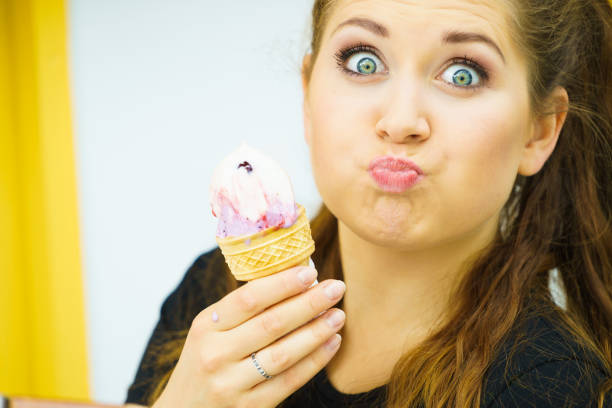 istock Young woman eating ice cream 1140011479