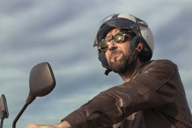 Attractive biker girl , making a turn on vintage motorcycle , motion blur added