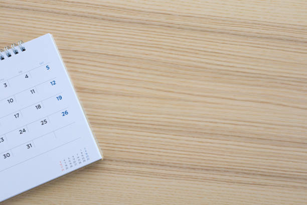istock calendar page on wood table background 1140015280