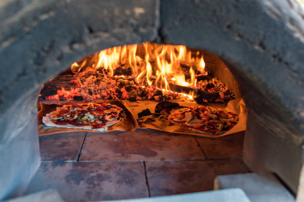 istock Italian pizza cooking in pizza oven over open flame 1140015520